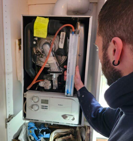 Gas Safe engineer servicing a boiler in London