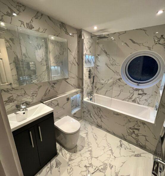 Luxury bathroom renovation with bath, vanity and toilet
